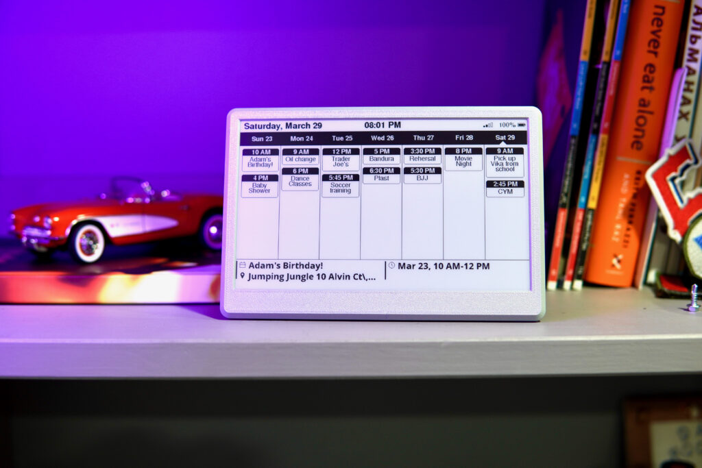 UkieLab 7.5″ e-ink calendar showing a week of events on a shelf with purple accent lighting