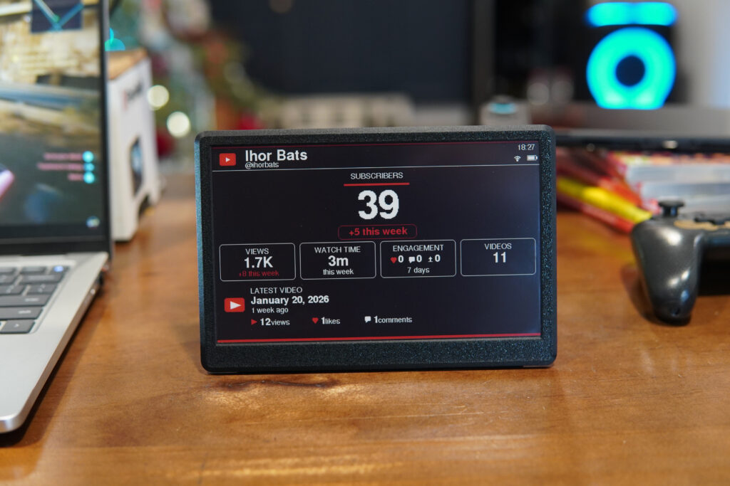 UkieLab subscriber counter for YouTube on a desk next to a laptop