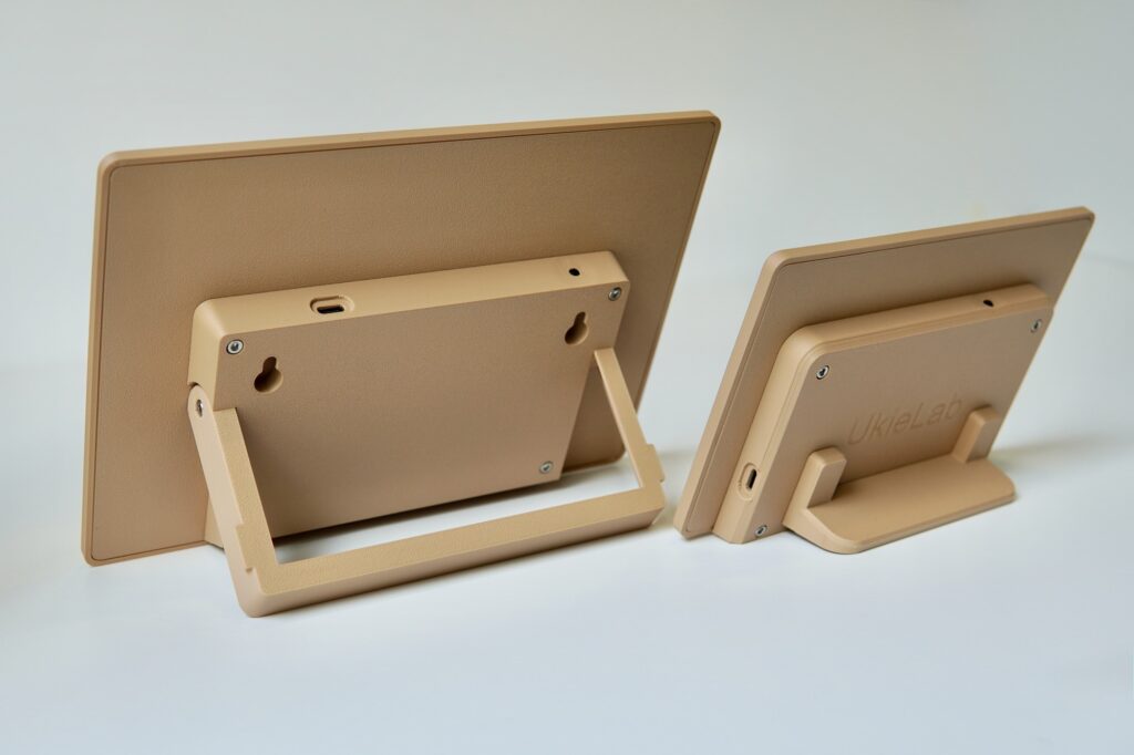 Back of two Ocean Tide displays showing the fold-out stand and wall-hanging keyholes